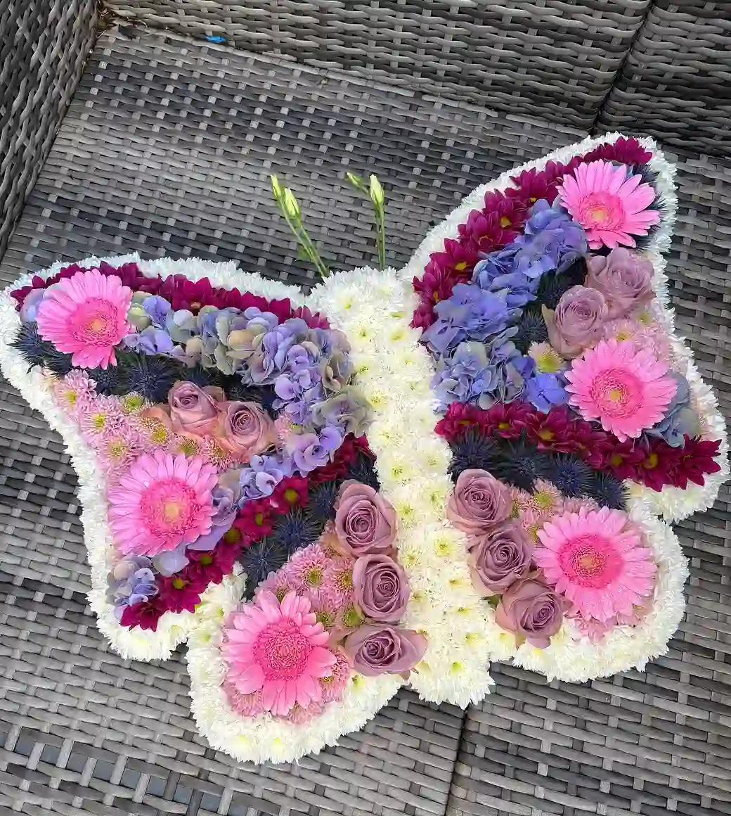 A bespoke butterfly funeral tribute hand-made by The Flower Shaq in pink gerberas, roses and hydrangea