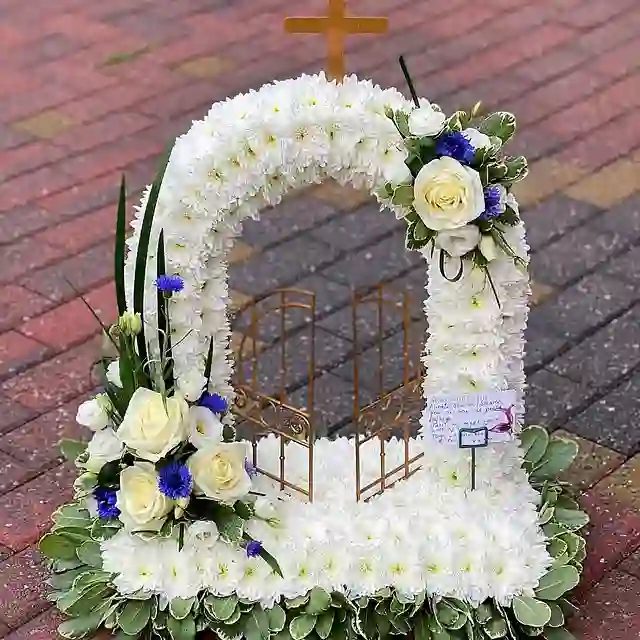 White arch and cross funeral tribute by The Flower Shaq